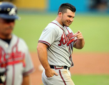 MIAMI GARDENS, FL - AUGUST 10:  Dan Uggla #26 of the Atlanta Braves celebrates against the Florida Marlins at Sun Life Stadium on August 10, 2011 in Miami Gardens, Florida.  (Photo by Marc Serota/Getty Images)
