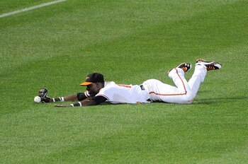 BALTIMORE, MD - AUGUST 10:  Felix Pie #18 of the Baltimore Orioles dives for and drops the ball hit by Juan Pierre (not pictured) of the Chicago White Sox at Oriole Park at Camden Yards on August 10, 2011 in Baltimore, Maryland.  (Photo by Greg Fiume/Gett