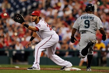 WASHINGTON, DC - JUNE 22: First basemen Michael Morse #38 of the Washington Nationals pulls in a throw to make an out against Chone Figgins #9 of the Seattle Mariners during the sixth inning at Nationals Park on June 22, 2011 in Washington, DC. The Washin