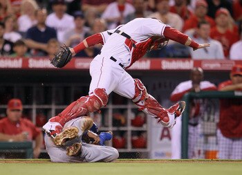 ANAHEIM, CA - JULY 19:  Elvis Andrus #1 of the Texas Rangers slips under the tag of catcher Jeff Mathis #5 of the Los Angeles Angels of Anaheim after being caught in a run down in the third inning at Angel Stadium of Anaheim on July 19, 2011 in Anaheim, C