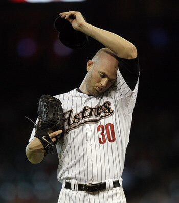 HOUSTON - AUGUST 05:  Pitcher J.A. Happ #30 of the Houston Astros wipes his brow in the third inning against the Milwaukee Brewers at Minute Maid Park on August 5, 2011 in Houston, Texas.  (Photo by Bob Levey/Getty Images)