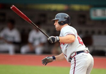 MIAMI GARDENS, FL - AUGUST 10:  Dan Uggla #26 of the Atlanta Braves hits an RBI single in the first inning against the Florida Marlins at Sun Life Stadium on August 10, 2011 in Miami Gardens, Florida.  (Photo by Marc Serota/Getty Images)