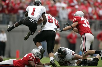 COLUMBUS, 0H - SEPTEMBER 2:  Garrett Wolfe #1 of the Northern Illinois Huskies jumps over Brandon Mitchell #32 of the Ohio State Buckeyes on his way to 172 yards rushing on September 2, 2006 at Ohio Stadium in Columbus, Ohio. Ohio State won the game 35-12