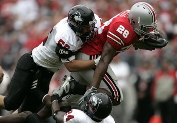 COLUMBUS, OH - SEPTEMBER 02:  Chris Wells #28 of the Ohio State Buckeyes tries to escape the tackles of Brandon Brice #56 and Bradley Pruitt #24 of the  Northern Illinois Huskies on September 2, 2006 at Ohio Stadium in Columbus, Ohio. Ohio State won the g