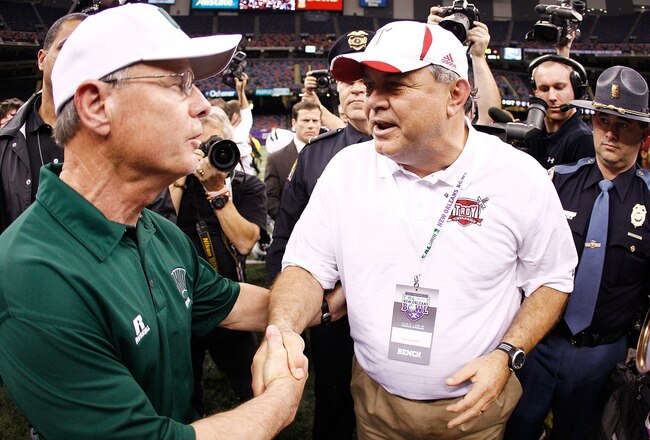 NEW ORLEANS, LA - DECEMBER 18:  Head coach Larry Blakeney of the Troy University Trojans is congratulated by Frank Solich, head coach of the Ohio University Bobcats  after the Trojans defeated the Bobcats 48-21 during the R&L Carriers New Orleans Bowl at