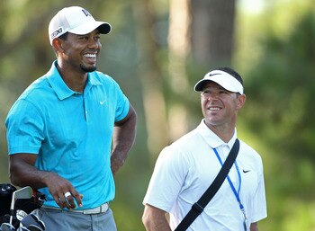 JOHNS CREEK, GA - AUGUST 10:  Tiger Woods (L) waits with swing coach Sean Foley (R) during a practice round prior to the start of the 93rd PGA Championship at the Atlanta Athletic Club on August 10, 2011 in Johns Creek, Georgia.  (Photo by Andrew Redingto