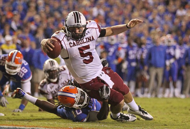 GAINESVILLE, FL - NOVEMBER 13:  Stephen Garcia #5 of the South Carolina Gamecocks rushes for a touchdown against Will Hill #10 of the Florida Gators during a game at Ben Hill Griffin Stadium on November 13, 2010 in Gainesville, Florida. The Gamecocks beat