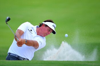 JOHNS CREEK, GA - AUGUST 12: Phil Mickelson hits out of a bunker on the first hole during the second round of the 93rd PGA Championship at the Atlanta Athletic Club on August 12, 2011 in Johns Creek, Georgia.  (Photo by Stuart Franklin/Getty Images)