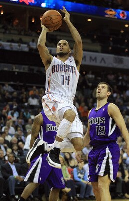 CHARLOTTE, NC - FEBRUARY 25:  Beno Udrih #19 of the Sacramento Kings watches as D.J. Augustin #14 of the Charlotte Bobcats shoots the ball during their game at Time Warner Cable Arena on February 25, 2011 in Charlotte, North Carolina. NOTE TO USER: User e