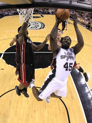 SAN ANTONIO, TX - MARCH 04:  Forward DeJuan Blair #45 of the San Antonio Spurs takes a shot against Mike Bibby #0 of the Miami Heat at AT&T Center on March 4, 2011 in San Antonio, Texas.   NOTE TO USER: User expressly acknowledges and agrees that, by down