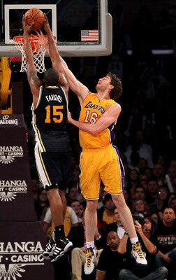 LOS ANGELES, CA - APRIL 05:  Pau Gasol #16 of the Los Angeles Lakers blocks a shot by Derrick Favors #15 of the Utah Jazz at Staples Center on April 5, 2011 in Los Angeles, California. The Jazz won 86-85.  NOTE TO USER: User expressly acknowledges and agr