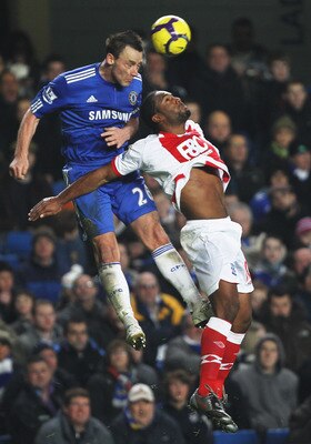 LONDON - JANUARY 27:  John Terry of Chelsea jumps with Cameron Jerome of Birmingham City during the Barclays Premier League match between Chelsea and Birmingham City at Stamford Bridge on January 27, 2010 in London, England.  (Photo by Hamish Blair/Getty