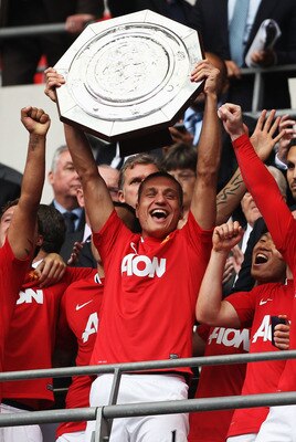 LONDON, ENGLAND - AUGUST 07:  Nemanja Vidic of Manchester United lifts the Community Shield after victory in the FA Community Shield match sponsored by McDonald's between Manchester City and Manchester United at Wembley Stadium on August 7, 2011 in London