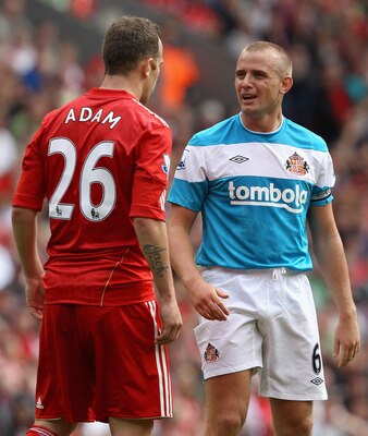 LIVERPOOL, ENGLAND - AUGUST 13:  Lee Cattermole of Sunderland reacts after a challenge by Charlie Adam of Liverpool during the Barclays Premier League match between Liverpool and Sunderland at Anfield on August 13, 2011 in Liverpool, England.  (Photo by C