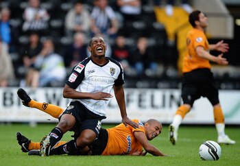 NOTTINGHAM, ENGLAND - JULY 23: Krystian Pearce of Notts County battles with Karl Henry of Wolves during the Pre Season Friendly between Notts County and Wolverhampton Wanderers at Meadow Lane on July 23, 2011 in Nottingham, England.  (Photo by Laurence Gr