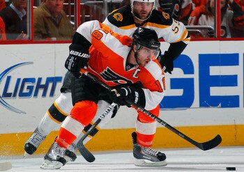 PHILADELPHIA, PA - MAY 02:  Mike Richards #18 of the Philadelphia Flyers skates with the puck in Game Two of the Eastern Conference Semifinals against the Boston Bruins during the 2011 NHL Stanley Cup Playoffs at Wells Fargo Center on May 2, 2011 in Phila