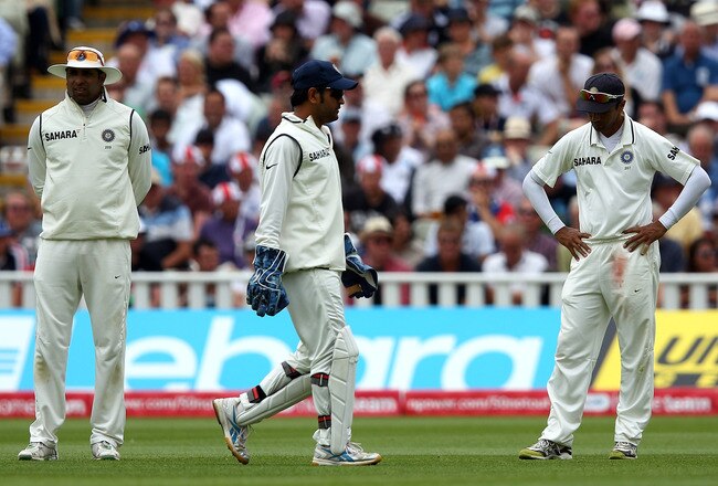 BIRMINGHAM, ENGLAND - AUGUST 11:  Rahul Dravid of India (R) reacts after dropping a catch as team mates VVS Laxman (L) and MS Dhoni look on during day two of the 3rd npower Test at Edgbaston on August 11, 2011 in Birmingham, England.  (Photo by Richard He