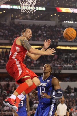 ARLINGTON, TX - FEBRUARY 14:  Deron Williams #8 of the Western Conference passes against Dwight Howard #12 of the Eastern Conference during the NBA All-Star Game, part of 2010 NBA All-Star Weekend at Cowboys Stadium on February 14, 2010 in Arlington, Texa