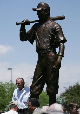 DENVER - JUNE 2:  World-renowned sculptor George Lundeen, stands next to his scuplure of 'The Player' in honor of the late Branch Rickey on June 2, 2005 in Denver, Colorado. The scuplture was presented by Rotary Club of Denver in commemoration of their an