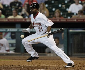 HOUSTON, TX - JULY 20: Michael Bourn #21 of the Houston Astros lays down a bunt single in the 5th inning against the Washington Nationals on July 20, 2011 at Minute Maid Park in Houston, Texas. Astros won in the bottom of the 11th 3 - 2. (Photo by Thomas