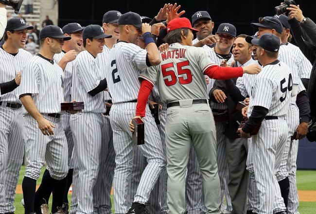 NEW YORK - APRIL 13: Hideki Matsui #55 of the Los Angeles Angels of Anaheim is greeted by former teammates of the New York Yankees after Matsui received his World Series ring for being a member of the 2009 New York Yankees Worlder Series Championship team