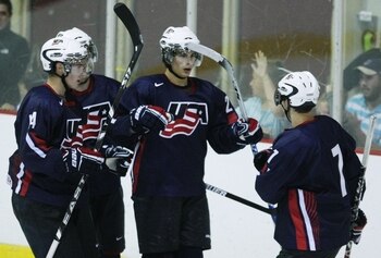 LAKE PLACID, NY - AUGUST 15:  Philip McRae #21 of Team USA celebrates his power play goal with teammatess against Team Russia during the Under-20 game at the 1980 Rink Herb Brooks Arena on August 15, 2009 in Lake Placid, New York. The United States won th