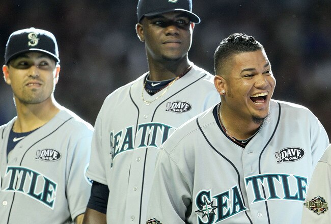 PHOENIX, AZ - JULY 12:  (R-L) American League All-Star Felix Hernandez #34 of the Seattle Mariners, American League All-Star Michael Pineda #36 of the Seattle Mariners and American League All-Star Brandon League #43 of the Seattle Mariners react during pl