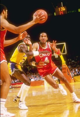 1986-1987:  Center Brad Daugherty (left) of the Cleveland Cavaliers makes a pass to team player guard  Ron Harper over the defense of the Los Angeles Lakers during a game at The Forum in Inglewood, California. Mandatory Credit: Stephen Dunn  /Allsport