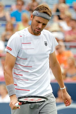 MONTREAL, QC - AUGUST 14: Mardy Fish of the United States examines his racquet between points while playing Novak Djokovic of Serbia during the final of the Rogers Cup at Uniprix Stadium on August 14, 2011 in Montreal, Quebec, Canada.  (Photo by Matthew S