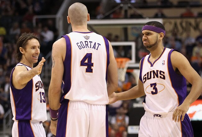 PHOENIX, AZ - JANUARY 30:  (L-R) Steve Nash #13, Marcin Gortat #4 and Jared Dudley #3 of the Phoenix Suns celebrate after scoring against the New Orleans Hornets during the NBA game at US Airways Center on January 30, 2011 in Phoenix, Arizona.  The Suns d