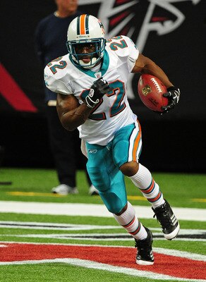 ATLANTA - AUGUST 12: Reggie Bush #22 of the Miami Dolphins carries the ball during warm-ups before their preseason game against the Atlanta Falcons at the Georgia Dome on August 12, 2011 in Atlanta, Georgia. (Photo by Scott Cunningham/Getty Images)