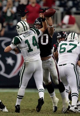 HOUSTON - AUGUST 15:  Quarterback Greg McElroy #14 of the New York Jets has his pass blocked by outside linebacker Bryan Braman #50 of the Houston Texans in the fourth quarter at Reliant Stadium on August 15, 2011 in Houston, Texas.  (Photo by Bob Levey/G