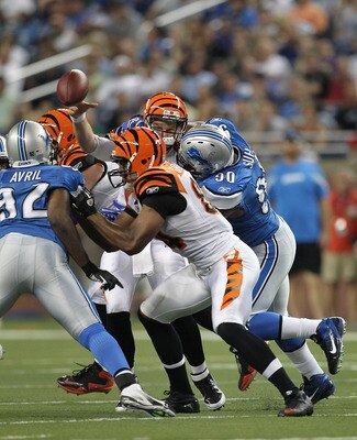 DETROIT - AUGUST 12: Ndamukong Suh #90 of the Detroit Lions hits quarterback Andy Dalton #14 of the Cincinnati Bengals in the second quarter and is called for a roughing the passer penalty during the game at Ford Field on August 12, 2011 in Detroit, Michi
