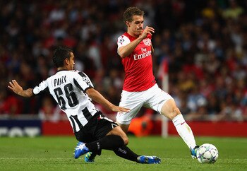 LONDON, ENGLAND - AUGUST 16:  Aaron Ramsey of Arsenal is tackled by Giampiero Pinzi of Udinese during the UEFA Champions League play-off first leg match between Arsenal and Udinese at the Emirates Stadium on August 16, 2011 in London, England.  (Photo by 