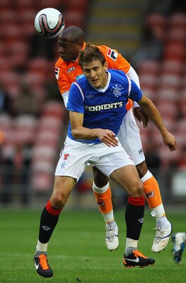 BLACKPOOL, ENGLAND - JULY 19:  Nikica Jelavic of Rangers and Matt Hill of Blackpool challenge for the ball during the Pre Season Friendly match between Blackpool and Rangers at Bloomfield Road on July 19, 2011 in Blackpool, England.  (Photo by Matthew Lew