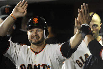 SAN FRANCISCO, CA - AUGUST 9: Cody Ross #13 of the San Francisco Giants celebrates after scoring on an RBI single by Orlando Cabrera #43 against the Pittsburgh Pirates in eighth inning during an MLB baseball game at AT&T Park August 9, 2011 in San Francis