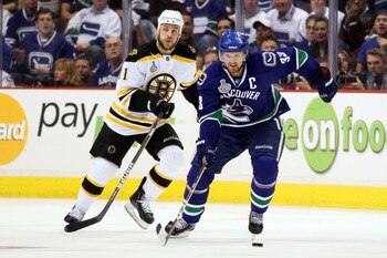 VANCOUVER, BC - JUNE 15:  Henrik Sedin #33 of the Vancouver Canucks skates against Gregory Campbell #11 of the Boston Bruins during Game Seven of the 2011 NHL Stanley Cup Final at Rogers Arena on June 15, 2011 in Vancouver, British Columbia, Canada.  (Pho