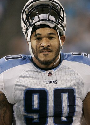 CHARLOTTE, NC - AUGUST 28:  Defensive end Derrick Morgan #90 of the Tennessee Titans rests his helmet on top of his head as he walks along the sidelines before the start of their preseason game against the Carolina Panther at Bank of America Stadium on Au
