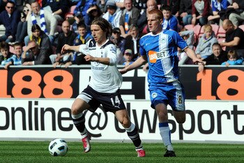 Luka Modric, left, in action against Wigan Athletic's Ben Watson