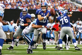 EAST RUTHERFORD, NJ - SEPTEMBER 26:  Eli Manning #10 of the New York Giants throws an interception in the endzone while being sacked by Cortland Finnegan #31 of the Tennessee Titans in the first quarter at New Meadowlands Stadium on September 26, 2010 in