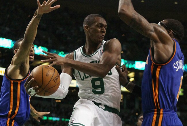 BOSTON, MA - APRIL 19:  Rajon Rondo #9 of the Boston Celtics looks to pass as Amare Stoudemire #1 and Toney Douglas #23 of the New York Knicks defend in Game Two of the Eastern Conference Quarterfinals in the 2011 NBA Playoffs on April 19, 2011 at the TD