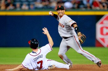 ATLANTA, GA - AUGUST 17:  Orlando Cabrera #43 of the San Francisco Giants attempts to turn a double play over Brooks Conrad #7 of the Atlanta Braves at Turner Field on August 17, 2011 in Atlanta, Georgia.  (Photo by Kevin C. Cox/Getty Images)