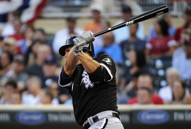 MINNEAPOLIS, MN - AUGUST 6: Paul Konerko #14 of the Chicago White Sox hits an RBI single against the Minnesota Twins in the fifth inning on August 6, 2011 at Target Field in Minneapolis, Minnesota. (Photo by Hannah Foslien/Getty Images)
