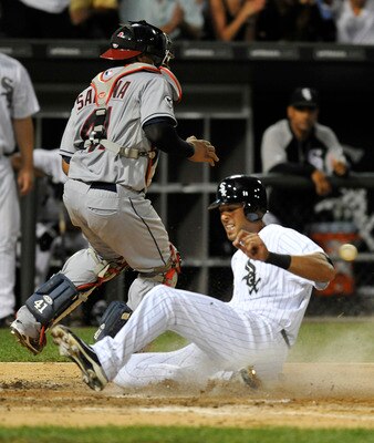 CHICAGO, IL - AUGUST 18: Alex Rios #51 of the Chicago White Sox slides home safely as Carlos Santana #41 of the Cleveland Indians gets the throw on August 18, 2011 at U.S. Cellular Field in Chicago, Illinois.  (Photo by David Banks/Getty Images)