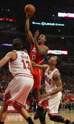 CHICAGO, IL - MAY 10: Jeff Teague #0 of the Atlanta Hawks puts up a shot between Joakim Noah #13 and Derrick Rose #1 of the Chicago Bulls in Game Five of the Eastern Conference Semifinals in the 2011 NBA Playoffs at the United Center on May 10, 2011 in Ch