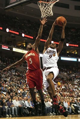 PHILADELPHIA - NOVEMBER 01:  Andre Iguodala #9 of the Philadelphia 76ers shoots under pressure from Josh Smith #5 of the Atlanta Hawks on November 1, 2006 at the Wachovia Center in Philadelphia, Pennsylvania. The Sixers defeated the Hawks 88-75.  NOTE TO