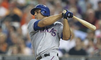 DETROIT - AUGUST 02: Nelson Cruz #17 of the Texas Rangers singes to left field scoring Josh Hamilton #32 in the fourth inning during the game against the Detroit Tigers at Comerica Park on August 2, 2011 in Detroit, Michigan.  (Photo by Leon Halip/Getty I