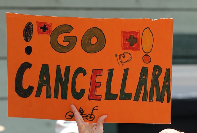 SACRAMENTO, CA - MAY 16:  Cycling fan Tracy Poff of San Francisco holds a sign supporting Fabian Cancellara as her son James, 4 ,rides her shoulders prior to the start of Stage One of the 2010 Tour of California from Nevada City to Sacramento on May 16, 2