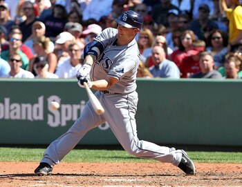 BOSTON - AUGUST 17:  Casey Kotchman #11 of the Tampa Bay Rays connects against the Boston Red Sox at Fenway Park on August 17, 2011 in Boston, Massachusetts.  (Photo by Jim Rogash/Getty Images)