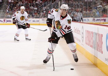 GLENDALE, AZ - MARCH 20:  Chris Campoli #14 of the Chicago Blackhawks skates with the puck during the NHL game against the Phoenix Coyotes at Jobing.com Arena on March 20, 2011 in Glendale, Arizona. The Blackhawks defeated the Coyotes 2-1.  (Photo by Chri